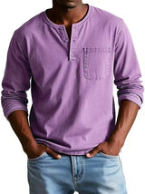 Person wearing a purple long-sleeve henley shirt with a pocket, standing against a white background.