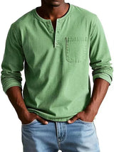 Person wearing a green long-sleeve henley shirt with a pocket, standing against a white background.