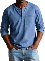 Man wearing a blue long-sleeve henley shirt and jeans on a white background